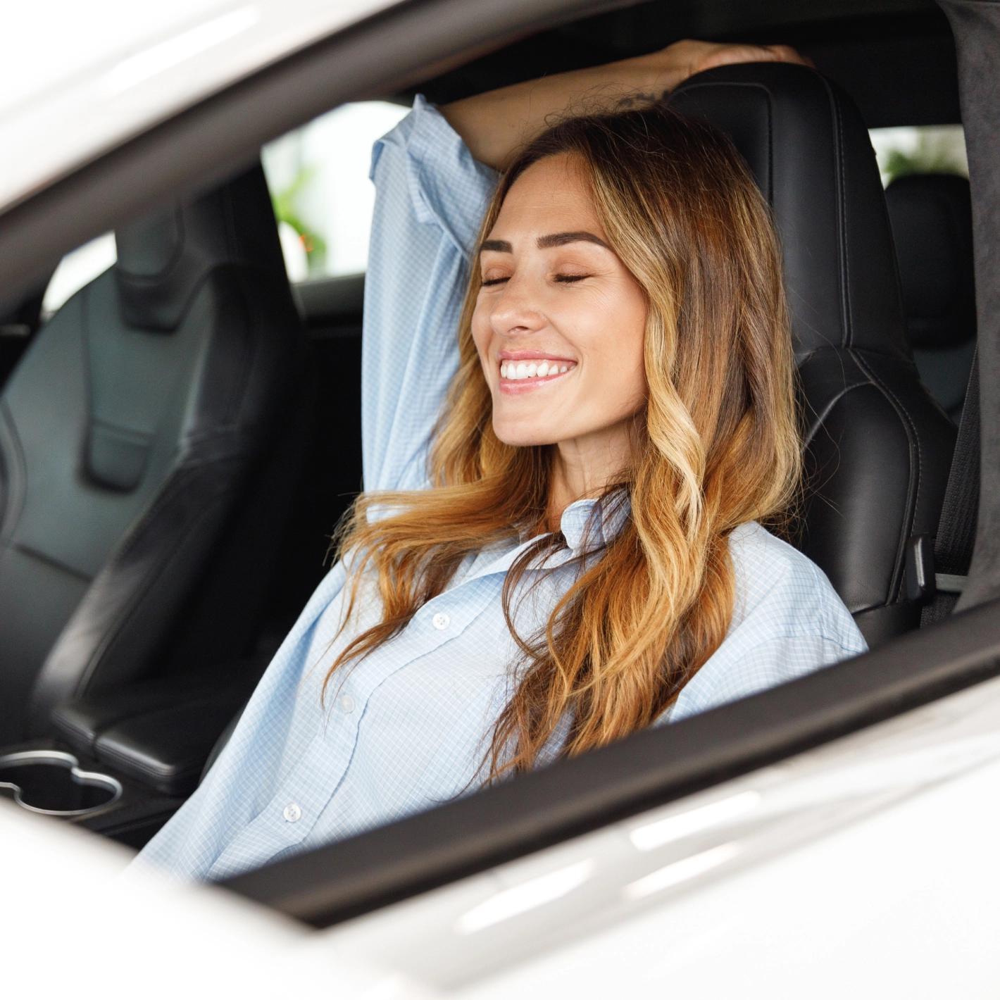 Immagine di una ragazza seduta comodamente dentro un auto, questa immagine esprime come i servizi accessori di Car Clinic siano studiati per garantire il massimo comfort a tutti i suoi clienti
